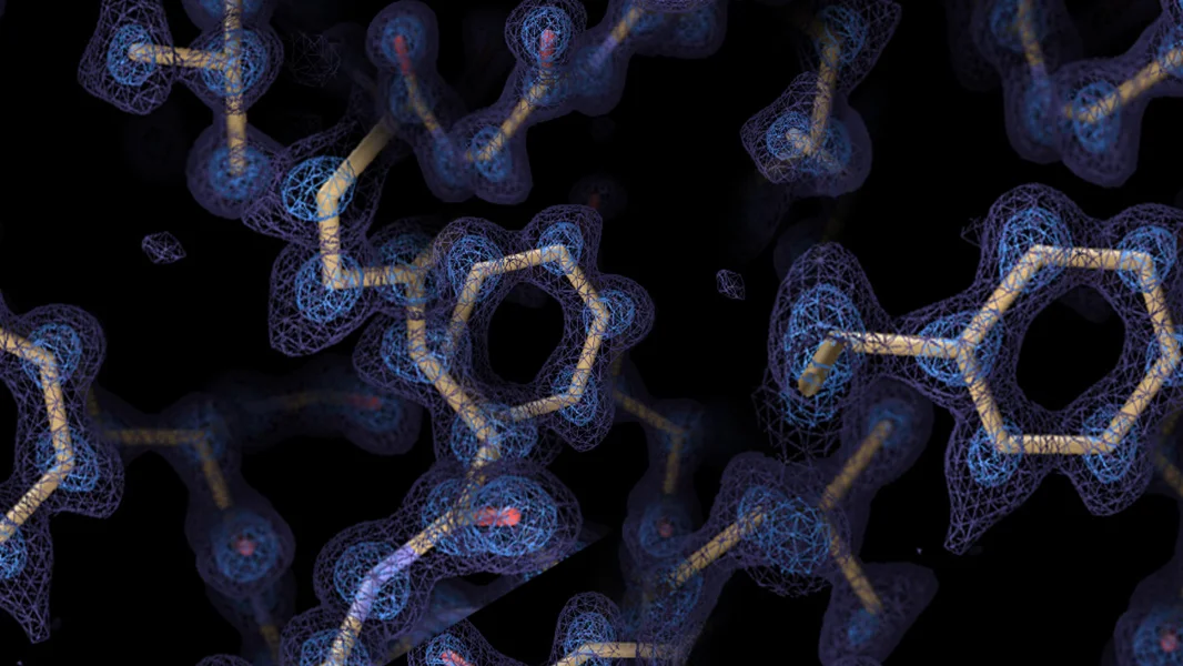 Protein structure with atomic model (yellow sticks) overlaid on a blue electron density map.