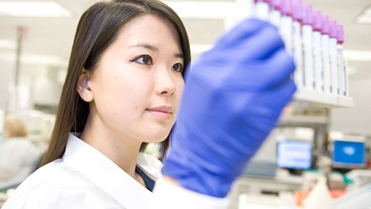 Lab member holding test tubes
