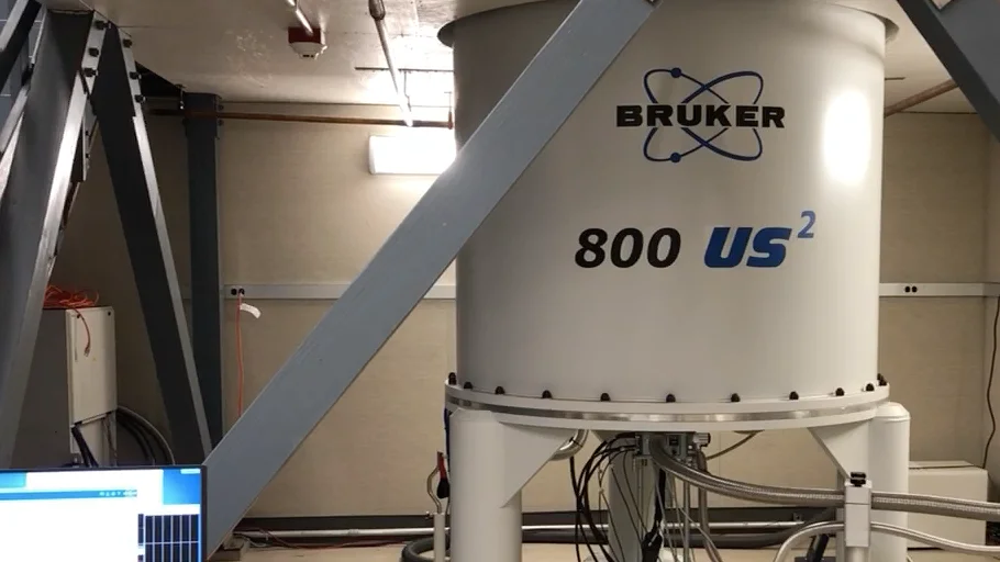 Bruker 800 US² NMR spectrometer system with surrounding support frame and control monitor.