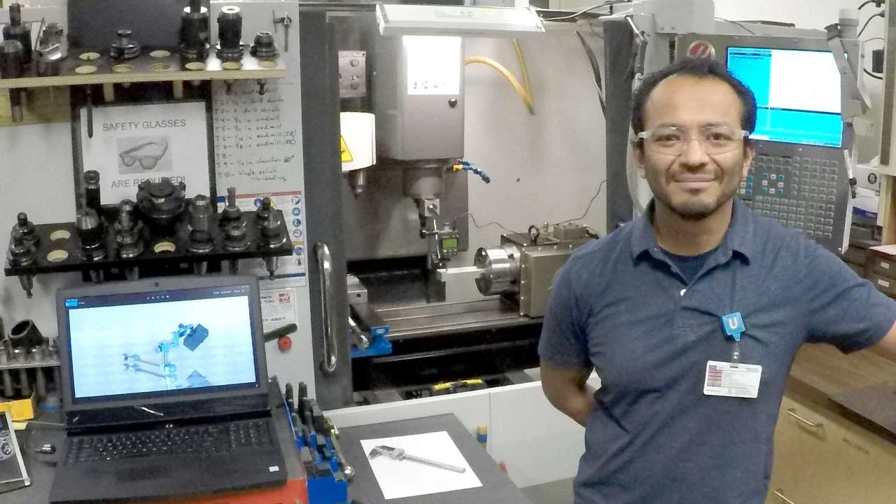 Jose Gomez standing by the Haas CNC 4 axis.