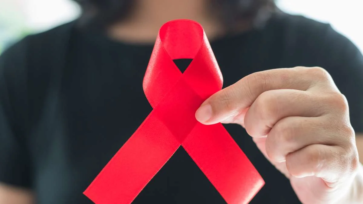 Woman holding AIDS ribbon
