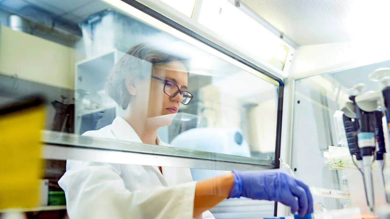 Researcher in lab with test tubes