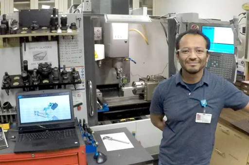 Jose Gomez standing by the Haas CNC 4 axis.