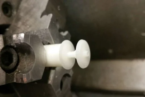 The CNC lathe holding a prototype of a unique seal for a custom high pressure valve.