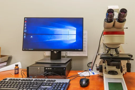 Leica DMI4 Microscope sitting next to a desktop computer.