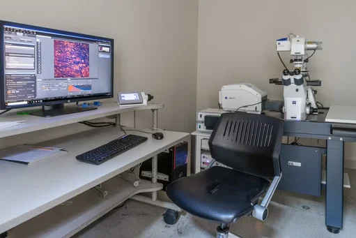  ZEISS Laser Confocal Scanning Microscope next to a desktop computer and chair.