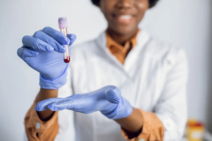 Lab technician holding blood test tube