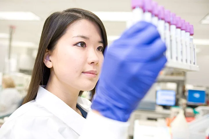 Lab member holding test tubes