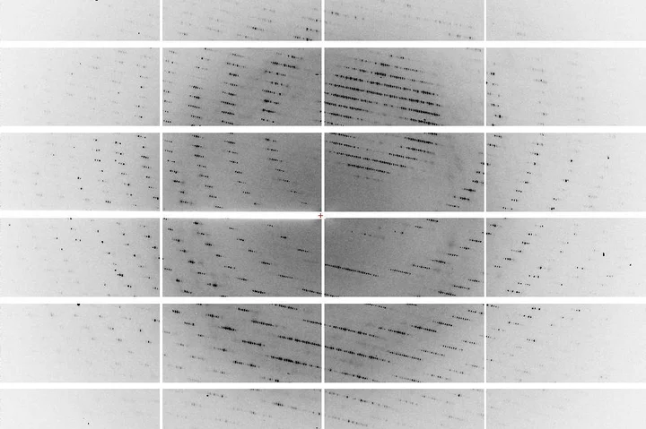 X-ray crystallography diffraction pattern showing concentric arcs of reflection spots on a segmented detector.