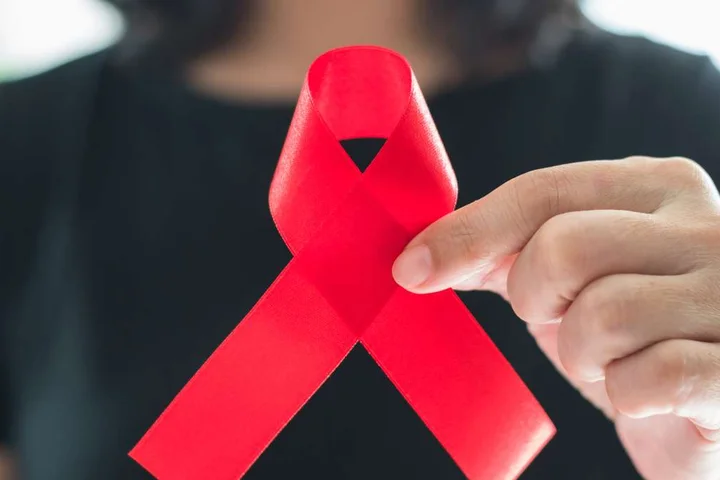 Woman holding AIDS ribbon