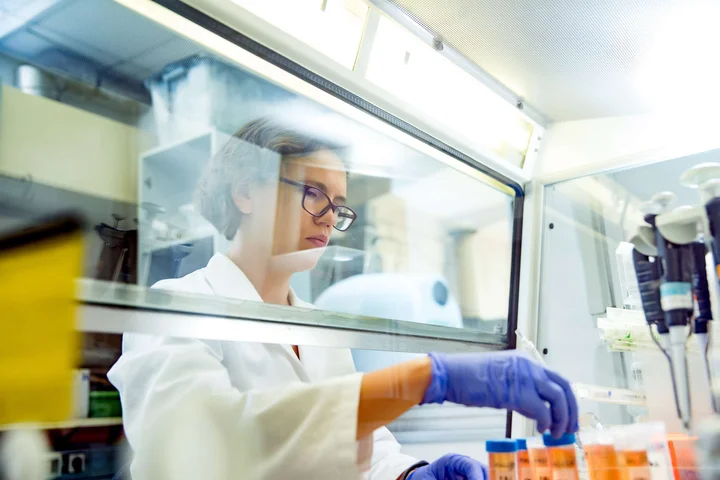 Researcher in lab with test tubes