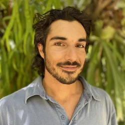 Headshot of Dr. Anthony Baniaga in the botanical garden